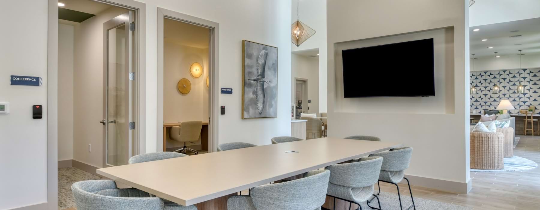 a conference room with a tv table and chairs