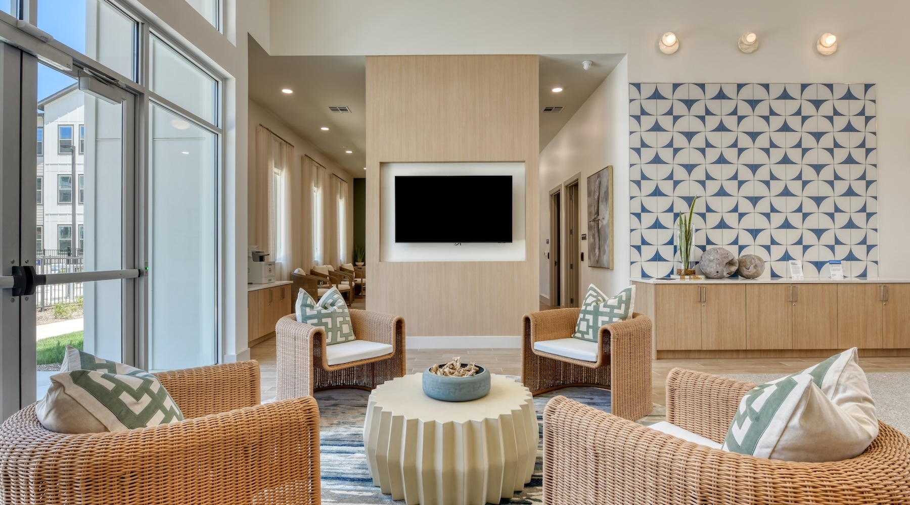 a clubroom with a tv, a table and chairs