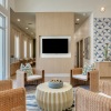 a clubroom with a tv, a table and chairs